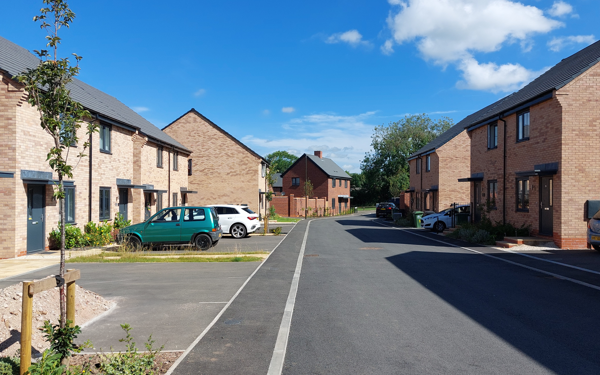 Street view of new homes at Hermitage Drive with properties to both sides