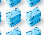 Photograph of stacks of blue protective facemasks