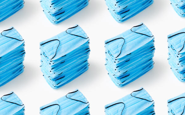 Photograph of stacks of blue protective facemasks