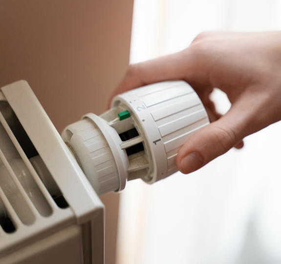 Close Up Hand Turning Up Heater