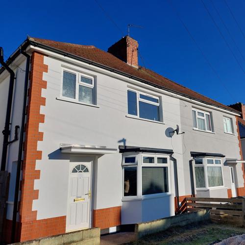 Page module - Image & text A photo of the front of a house that's received external wall insulation.