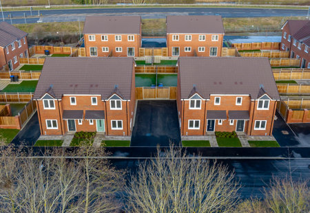 Aerial view of a small modern housing development on what looks like a cold day