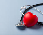 Stethoscope next to a red 3D love heart