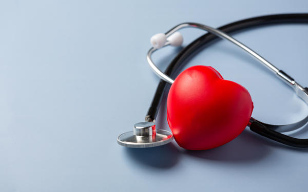 Stethoscope next to a red 3D love heart