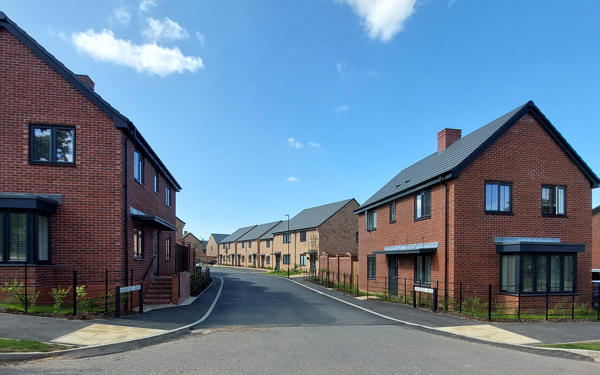 Street view of new homes at Hermitage Drive with properties to both sides